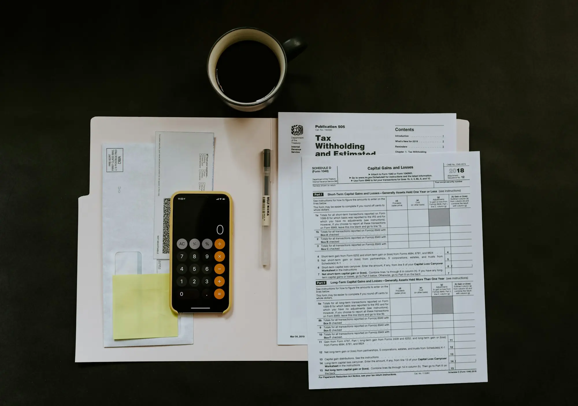 Official letters and a calculator spread across a small business desk