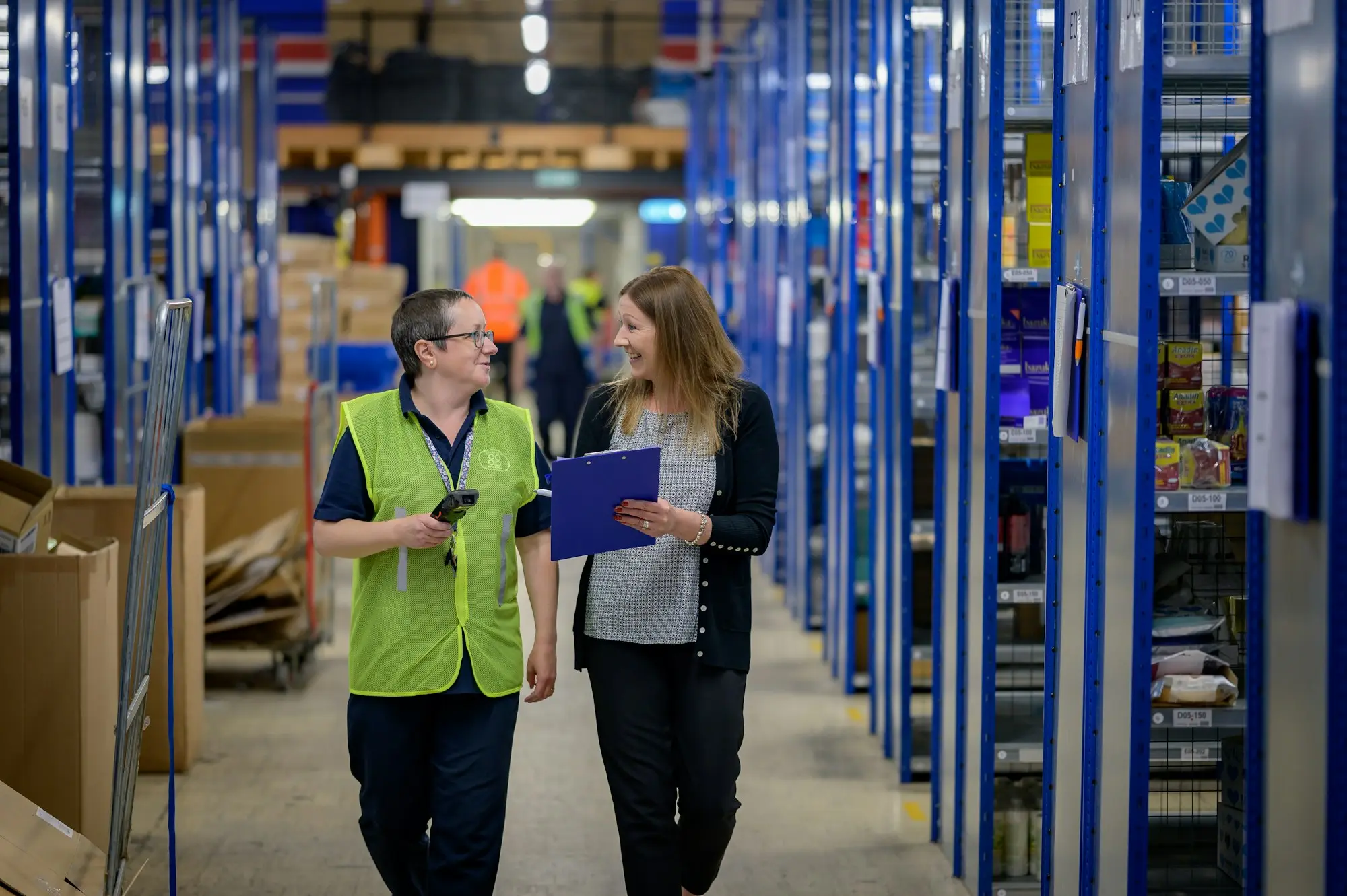 Warehouse manager looking at near-empty shelves and pallets